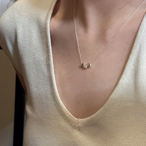 Minimalist S925 silver necklace with three cylindrical beads worn on a model in V-neck