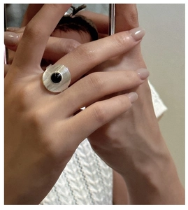 Detailed view of an S925 silver ring with black onyx inlay and concentric circular texture