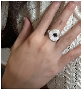 Detail of S925 silver ring with concentric circle textures and a black onyx stone