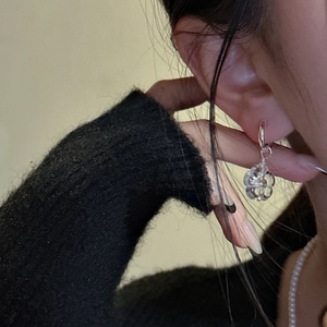 Elegant S925 silver hoop earrings with clear resin daisy floral pendants on a model