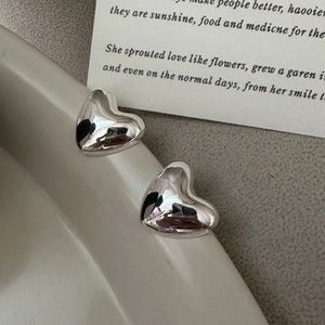 S925 sterling silver heart stud earrings with a polished mirror finish on a white background