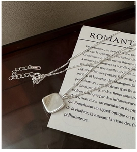 Macro shot of S925 sterling silver square pendant necklace with lobster clasp and tag