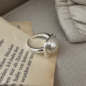 Minimalist S925 sterling silver ring with large white pearl in square setting on vintage paper