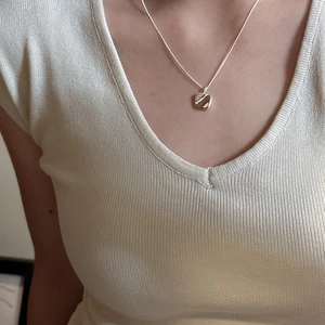 Minimalist S925 sterling silver square pendant necklace worn on a woman's collarbone