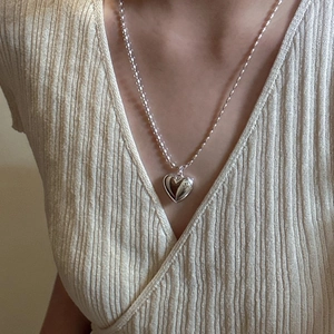 Minimalist S925 sterling silver long necklace featuring a hollow heart pendant on a model