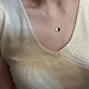 S925 sterling silver minimalist round pendant necklace worn on neck with a thin chain