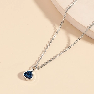Elegant silver O-chain necklace featuring a teardrop pendant with blue druzy stone