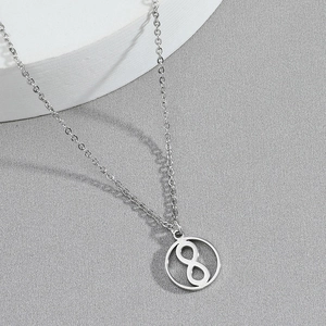 Minimalist silver hourglass pendant necklace with infinity symbol on grey background
