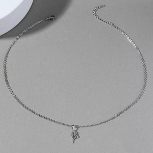 Stainless steel hollow rose pendant necklace with adjustable O-chain on grey background