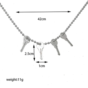 Detailed view of silver bead chain necklace with four key pendants including dimensions