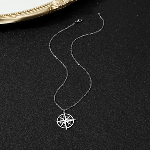 Close-up of north star disc pendant with intricate cutout on a fine silver O-chain link