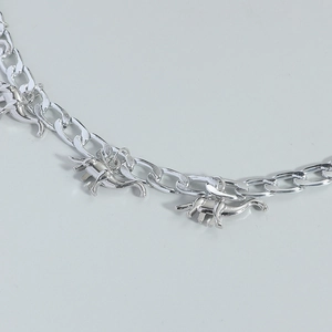 Silver Cuban link necklace featuring multiple dinosaur pendants in a minimalist style