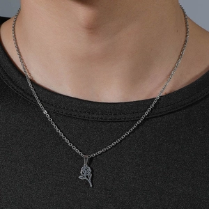 Silver stainless steel hollow rose pendant necklace on male model with black t-shirt