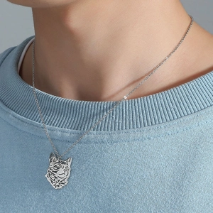 Silver hollow cat head pendant necklace on model with minimalist stainless steel design