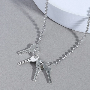Silver bead chain necklace for men featuring four minimalist key-shaped metal pendants