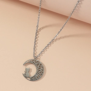 Silver hollow crescent moon necklace with a sitting cat silhouette on a bi-color background