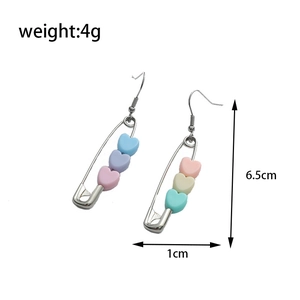 Detail view of macaron heart paperclip earrings showing 6.5cm length and 4g weight