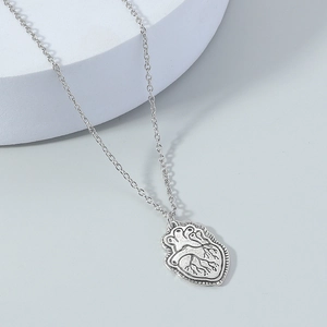 Realistic human anatomical heart pendant on a thin silver O-chain necklace