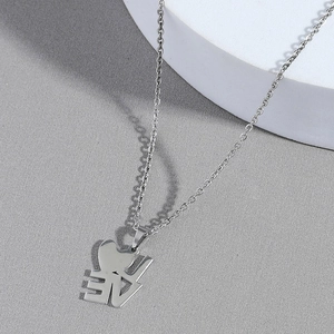 Silver stainless steel LOVE heart pendant necklace on minimalist gray textured background