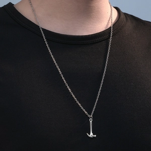 Men's minimalist hammer pendant necklace in silver stainless steel on a black t-shirt