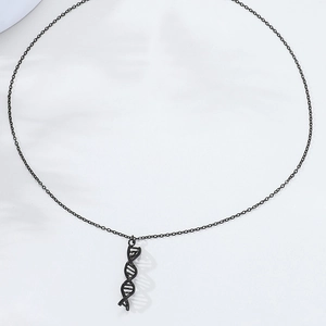 Detailed view of the black metal DNA double helix pendant on a fine link chain necklace