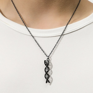 Close-up of black DNA double helix pendant on a minimalist metal chain necklace