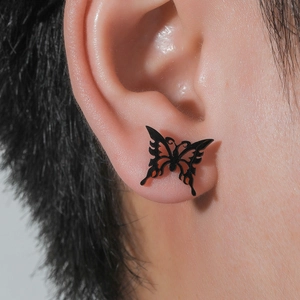 Matte black stainless steel butterfly stud earring with cutout texture on model ear