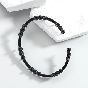 Minimalist black twisted open cuff bracelet for men and women with matte finish texture
