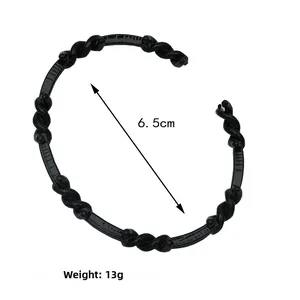 Macro detail of black twisted rope cuff bracelet with 6.5cm inner diameter measurement