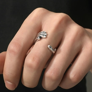 Close-up of vintage hip-hop skeleton hand embrace ring with adjustable open design