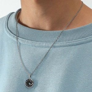 Detail of couple necklace with mini black watch dial pendant on silver chain