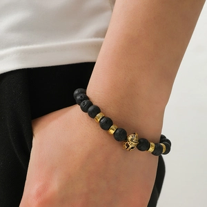Men's lava rock bead bracelet with golden Spartan helmet charm and metallic spacers