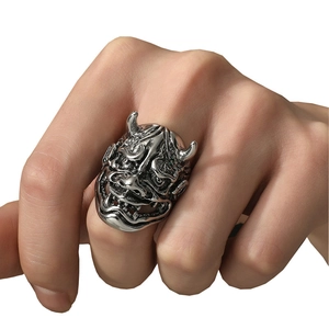 Gothic punk silver bull skull ring for men with detailed demon mask carvings on a white background
