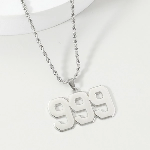 Detailed macro view of the 999 number pendant on a silver-tone hip hop rope chain