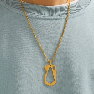Detail of gold multi-tool pendant necklace with bottle opener and wrench on model
