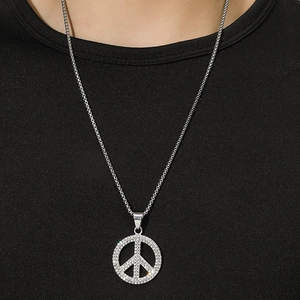 Hiphop silver peace sign necklace with pavé crystal pendant on a black model top