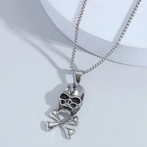 Punk style silver skull and crossbones pendant necklace with steel box chain on white