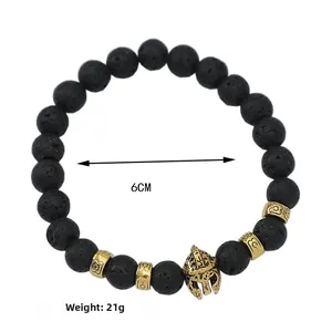 Detail of black lava stone bracelet with a golden Spartan helmet charm and 6cm diameter