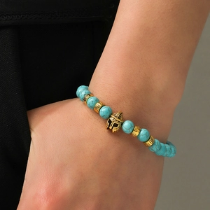 Macro detail of agate beads bracelet featuring a golden Spartan helmet and vintage spacers