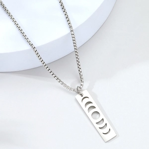 Detailed view of silver moon phase cutout rectangle pendant on a sturdy box chain necklace