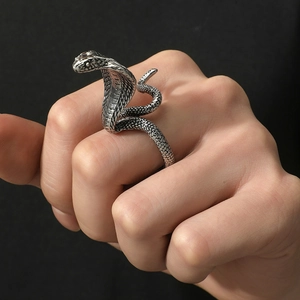 Punk cobra wrap ring with detailed scales and vintage silver finish on model's hand