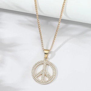 Detailed view of gold peace sign pendant featuring sparkling crystals on a box chain link