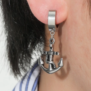 Close-up of a silver anchor pendant earring with rope detail on male model