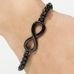 Close-up of black infinity symbol bracelet with a stylish square box chain on wrist