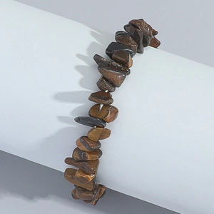 Detailed view of natural tiger eye stone chips bracelet on a white display stand