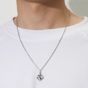 Punk style silver anchor pendant necklace with rope detail for men on white shirt