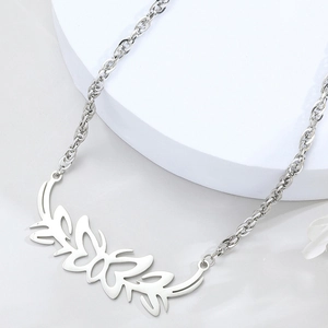 Minimalist silver tribal butterfly necklace with thick twisted chain on white pedestal