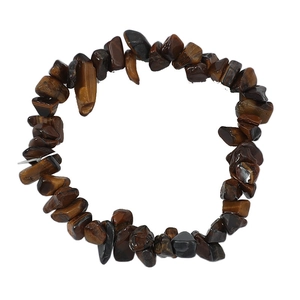 Macro view of irregular natural tiger eye stone beads on a minimalist beaded bracelet