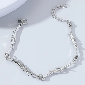Detail showing the adjustable lobster clasp and thorn-style metal chain design