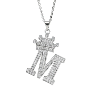 Silver crown letter M pendant necklace with sparkling cubic zirconia on white background